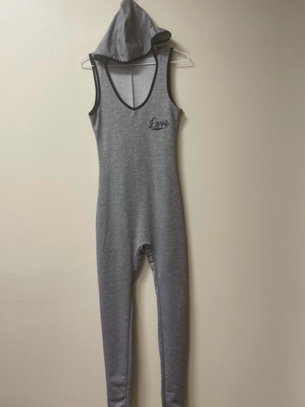 Adorable light gray sleeveless jumpsuit with a hood